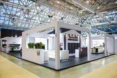 an exhibition stand with plants on the floor