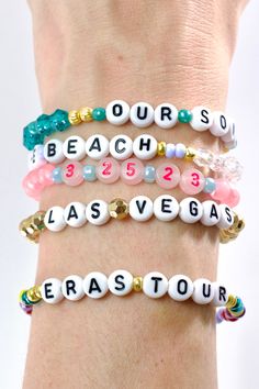 four bracelets with beads and charms that say,'our beach is las vegas '