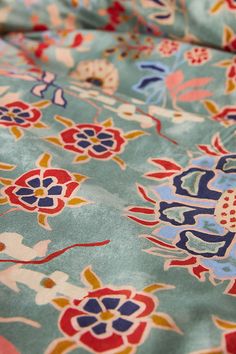 a blue and red floral print fabric with flowers on it