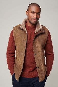 For a shearling vest that you can wear almost every day of the year, our Trailblazer fits the bill. On the coldest days, layer this hard worker with a thermal knit underneath your favorite winter coat on top. But when you just need a little extra warmth on a brisk, sunny day, pair it with your favorite shirt and take it out for a spin on a winding country road or a bustling city street. Oval Body Shape, Sheepskin Vest, Mens Smart Casual Outfits, Guy Gifts, Vest For Men, Coats For Men, Shearling Vest, Guys Clothing Styles, Sheepskin Coat