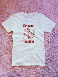 We Grow Together Tee Available in Natural w/ red screen printed graphic Available in sizes S, M, L, XL, XXL Made and printed in small batches in the USA Red Band Merch Tops With Screen Print, Red Band Merch Top With Screen Print, Red Band Merch Shirt With Screen Print, Unisex Pre-shrunk Red T-shirt, Unisex Red Cotton T-shirt, Unisex Red Screen Print Tops, Unisex Red T-shirt With Letter Print, Red Letter Print Unisex T-shirt, Red Letter Print T-shirt, Unisex Fit