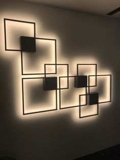 a white wall with some square lights on it