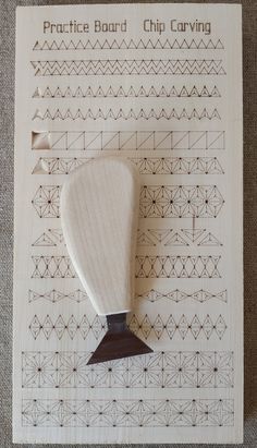 a wooden stamper sitting on top of a piece of paper next to a pattern