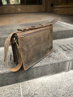 Minimalist leather briefcase, simple double gusset, made by hand in NYC. Only human hands no machines. For more leather briefcases, messengers, satchels, carryalls, laptop bags, crossbody bags, click here http://etsy.me/1mfOvP3. Handmade double compartment bag, hand sewn without the use of glues, or machines and even electricity. Made to order - made from scratch, leaving room for customization and personalization. The double compartment bags are stronger than the single gussets and can carry mo Rectangular Business Briefcase With Leather Strap, Classic Rectangular Briefcase For Everyday Carry, Leather Saddle Bag With Waxed Finish For Business, Business Leather Saddle Bag With Waxed Finish, Business Saddle Bag With Waxed Finish And Rectangular Shape, Rectangular Business Saddle Bag With Waxed Finish, Rectangular Leather Strap Briefcase For Office, Business Rectangular Saddle Bag With Waxed Finish, Classic Briefcase With Leather Strap