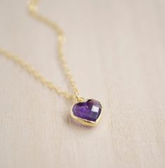 Give yourself some love or show your love for that special someone in your life with this heart necklace!Amethyst is believed to carry the energies of passion, creativity, and spirituality. It's also said to assist with temperance and sobriety, as well as inflammation.This necklace is handcrafted with a purple Amethyst faceted heart pendant. Each stone is natural and therefore contains natural inclusions or crystal formations. They are edged in 24k gold or silver electroplate. STONE SIZE: averag Everyday Gemstone Heart Pendant Necklace, Spiritual Necklace With Heart Charm, Amethyst Crystal Necklaces For Gifts, Amethyst Crystal Necklace Gift, Dainty Heart-shaped Birthstone Necklace With Gemstone, Spiritual Heart Pendant Necklace For Gift, Spiritual Heart Pendant Necklace As Gift, Spiritual Charm Necklace For Valentine's Day Gift, Spiritual Birthstone Necklace As Gift