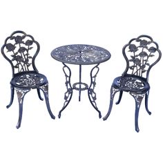 an iron table and two chairs with flowers on them