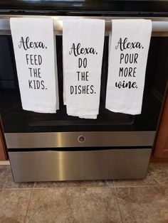 three tea towels that are on top of an oven