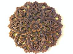 an intricately carved wooden object on a white background