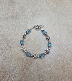 one of a kind sterling bracelet, vintage beaded bracelet, blue Swarovski jewelry Sterling Silver and Swarovski Crystal Handmade Bracelet 7 " all 4mm round beads are sterling silver. All square spacer beads, bead caps and toggle clasp are Bali sterling silver. Swarovski crystals are 8mm round aquamarine Check out my other jewelry at https://loveofjewelryshop.etsy.com Adjustable Blue Crystal Bracelet For Anniversary, Adjustable Blue Bracelets For Anniversary, Sterling Silver Beaded Charm Bracelet Gift, Beaded Sterling Silver Charm Bracelet Gift, Adjustable Blue Birthstone Jewelry, Nickel-free Blue Sterling Silver Charm Bracelet, Adjustable Blue Bracelets With Birthstone, Adjustable Blue Birthstone Bracelets, Adjustable Blue Bracelet With Birthstone