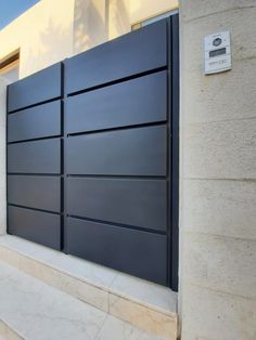 a large black gate on the side of a building