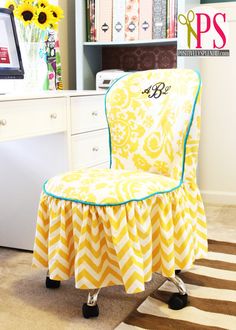 a yellow and white chair sitting in front of a desk