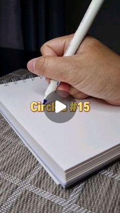 a hand holding a pen writing on top of a notebook with the word circle 15