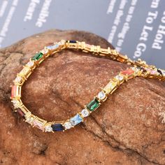 Rainbow Sapphire and cubic zircon  Stackable Eternity tennis  Bracelet Simple Line Bracelet Dainty emerlad Cut Tennis Bracelet Gradient Multicolor Gemstone Boho Gift  | emerald cut lab grown gemstone tennis bracelet gold | Art Deco vintage emerald bracelet gold best gift for her  Item Details Metal: 925 Sterling Silver Main stone creation-  Multi Sapphire  (lab created) Main Stone Color: multi Main Stone Shape: Emerald cut Stone Sizes: Rainbow Sapphire Baguette 5x3mm Faceted Stone Sizes:  CZ  Round 3mm Faceted Cutting technique- Cut Theme: Dainty, Statement & Engagement Method: handmade Personalization: Possible Occasion: Wedding bracelet, engagement bracelet, birthday bracelet, bracelet for her, proposal best bracelet Style: Minimalist Bracelet Size: We make bracelet length =  5 , 5.50, 6 Crystal Tennis Bracelet With Jubilee Design, Cubic Zirconia Tennis Bracelet With Jubilee Design, Cubic Zirconia Jubilee Tennis Bracelet Gift, Crystal Jubilee Tennis Bracelet Gift, Multicolor Cubic Zirconia Tennis Bracelet Gift, Cubic Zirconia Tennis Bracelet With Sparkling Stones, Multicolor Cubic Zirconia Tennis Bracelet For Anniversary, Emerald Bracelet Gold, Armband Gold