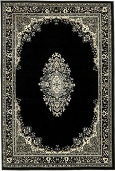 black and white rug with an ornate design on the center, surrounded by smaller floral designs