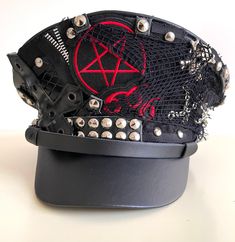 Gothic Punk Military hat with pentagram Badges and cross with studs all round the front  This is a black leather look Military style hat with front metal studs Please refer to photos. Available in size 56,57,58,59cm Please note:- Even though there is a choice of sizes, these are made to order and are customise to your requirements . I do not carry stock and hence do not do refunds. Please check the sizes before you commit to your purchase. Thank you Thank you for looking. Goth Hats, Punk Grunge Outfits, Steam Punk Fashion, Punk Hats, Hat With Patches, Punk Hat, Goth Hat, Punk Clothes, Patches For Clothes