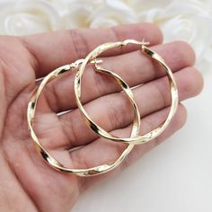 Stunning real 14k yellow gold polished 3mm thick twisted hoop earrings. Perfect for everyday and special occasions. Shiny, elegant and versatile. Perfect gift for her. A must have in your earrings collection. Materials: 14k Yellow Gold Diameter: 46mm Thickness: 3mm Weight: approximately  3.9 grams 14k stamped Brand new  Fast shipping  Check out or 42mm 14k Gold 3mm Twisted Hoop Earrings: https://www.etsy.com/BrizaCollections/listing/1440449027/real-14k-gold-3mm-twisted-hoop-earrings?utm_source=C Cheap Gold Hoop Jewelry, Cheap Gold Hoop Earrings For Party, Cheap Elegant Hoop Earrings, Cheap Elegant Hoop Earrings With Polished Finish, Cheap Gold Plated Earrings For Gift, Cheap Gold Alloy Earrings, Cheap Modern Gold Plated Hoop Earrings, Cheap Elegant Polished Hoop Earrings, Affordable Gold Hoop Earrings For Party