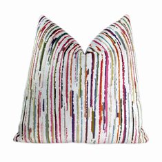 a multicolored striped pillow on a white background