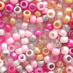 many different colored beads are shown together in this image, including pinks and silvers