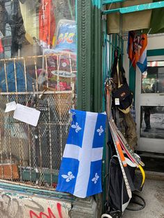 there are many skis and snowboards in the store window display, including one with a flag on it