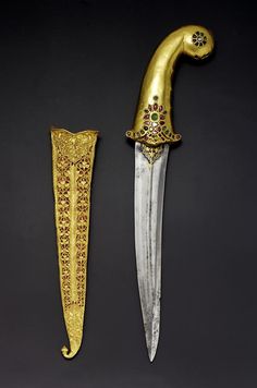 two gold - plated knives with elaborate designs on them