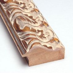 a close up of a wooden object on a white surface