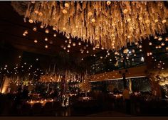 a room filled with lots of lights and chandeliers hanging from it's ceiling