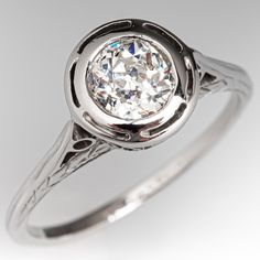 an antique style diamond ring on a white background