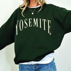 Elevate your outdoor style with our Yosemite National Park Crewneck - a sweatshirt that is inspired by the beauty of the park and the love of vintage design. It is a perfect souvenir and crafted for National Park enthusiasts and explorers of the great outdoors.  Color - Forest Green For an oversized look, we recommend ordering 1 to 2 sizes larger than your regular size. This item is made to order and is printed using a DTG (direct to garment) method. This is not embroidered or screen printed. Material & Comfort: * 50% cotton, 50% polyester (8.0 oz/yd²) for cozy warmth. * Classic fit, crew neckline for a clean-cut style. * Double-needle stitching for durability. * The collar is ribbed knit, ensuring it retains its shape even after washing. Fall Outdoor Crew Neck Sweatshirt, Fall Crew Neck Sweatshirt For Outdoor, Casual Outdoor Sweater With Letter Print, Casual Letter Print Sweater, Crew Neck Sweater With Letter Print For Outdoor, Crew Neck Letter Print Sweater For Outdoor, Outdoor Letter Print Sweatshirt Crew Neck, Outdoor Crew Neck Sweatshirt With Letter Print, Letter Print Sweatshirt For Outdoor Activities In Fall