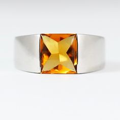 This stunning 14K solid white gold ring features a 1.6 carat canary yellow natural citrine stone in a chic Cartier style setting. The square-shaped citrine adds a pop of vibrant colour to the simple yet elegant design, making it a perfect ring for any special occasion. Crafted with high-quality materials, this fine jewellery piece is a luxurious addition to any collection. With a classic yet modern design, this piece is ideal for those who appreciate fine craftsmanship and unique gemstones. Perf Modern Gold Topaz Ring, Modern Yellow Topaz Ring For Anniversary, Modern Yellow Topaz Anniversary Ring, Modern Citrine Rings For Formal Occasions, Modern Yellow Rings For Anniversary, Modern Yellow Gold Topaz Ring With Rectangular Shape, Modern Formal Hallmarked Topaz Ring, Modern Yellow Jewelry With Polished Finish, Modern Yellow Gemstone Rings