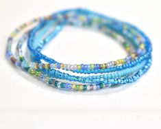 Ocean Vibes 11/0 Seed Bead Bracelet Set This listing is for all 5 bracelets shown. They are made with super tiny size 11/0 Czech seed beads. The beads are 1mm-2mm. They are made on clear stretch cord and a small clear knot shows. You will receive one of each of the colors shown.  These bracelets stretch and slide over your hand. It's best not to pull them too much, but instead put your hand in and slide or roll them into place on your wrist. Also, it's best to not get them wet. :) To determine y Seed Bead Stretch Bracelets, Bead Stretch Bracelets, Blue Bracelets, Stack Bracelets, Beads Craft Jewelry, Beads Craft, Seed Bead Bracelet, Ocean Vibes, Craft Jewelry