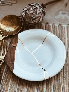 a place setting with pineapples and silverware