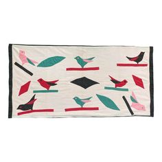 a white wall hanging with birds on it