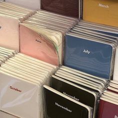 many different colored folders stacked on top of each other