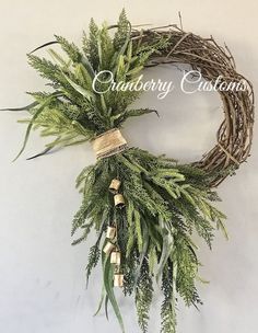 a wreath with greenery hanging on the wall