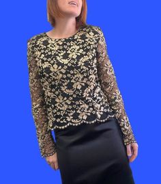 Designer 90s does medieval style black and gold lace blouse. Think grungy Drew Barrymore or even Courtney Love. Round neck with button down back and long, sheer lace sleeves with scalloped cuffs. The hemline is also scalloped. Well made with beautiful quality fabric and just the right amount of edginess. Great vintage condition with minimal signs of wear. Brand is Geoff Bade made in Australia. Sized 14 but would best fit up to size 12 modern Australian women's sizing. MEASUREMENTS (AS PER LABEL) Gothic Party Tops With Lace Sleeves, Evening Long Sleeve Blouse With Lace Work, Gold Long Sleeve Top For Evening, Evening Lace Patchwork Long Sleeve Top, Evening Long Sleeve Lace Patchwork Top, Gothic Lace Tops For Party, Gothic Lace Party Tops, Festive Elegant Lace Blouse, Elegant Festive Lace Blouse