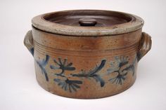 a brown and blue pot sitting on top of a white table