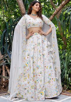 Faux Georgette Lehenga in White. This attire with Cotton Lining is Enhanced with Resham, Multicolor Sequins Embroidery Work along with Fancy Tassels and Can Can Net. Available with Readymade Faux Georgette White Choli and a Faux Georgette Dupatta in White The Semi-stitched Lehenga Waist and Hips are customizable from 24 to 62 and 28 to 66 inches. Lehenga Length is 40 inched Do Note: Accessories shown in the image are for presentation purposes only and length may vary upto 2 inches.(Slight variat Diwali Embellished Multicolor Embroidery Sets, Multicolor Floral Embroidery Lehenga For Diwali, White Floral Embroidered Dress For Navratri, Embellished Multicolor Georgette Set, Diwali Floral Embroidery Multicolor Lehenga, White Georgette Lehenga With Floral Embroidery, White Floral Embroidered Lehenga For Navratri, White Floral Embroidered Georgette Lehenga, White Lehenga With Floral Embroidery For Party