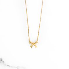 Necklace embellished with a tiny stainless steel yellow gold bow charm and comes with an adjustable 16-18" chain. Gold Necklace With Ribbon For Gift, Gold Necklace With Ribbon Perfect For Gifts, Gold Bow Necklaces For Gifts, Gold Necklaces With Bow For Gifts, Gold Necklaces With Bow As Gifts, Gold Necklace With Bow For Gifts, Gold Necklace With Bow As Gift, Dainty Gold Jewelry With Ribbon, Gold Necklaces With Bow Detail