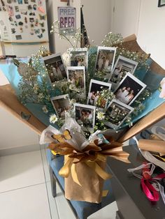 a bouquet of flowers with pictures on it sitting on a blue chair in front of a wall