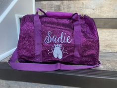 "Medium 12\" NGIL Purple Glitter Duffle Bag  Personalized with name and Dance Shoes or Ballerina Silhouette ( If wanting a different design just contact me) This glimmering petite duffle bag is perfect as a flight bag when traveling, for running errands, or for everyday use. It's also the perfect carry-all for your little girl's recitals, camp, or sleepovers! Glitter Covered Fabric Construction Zip Top Closure Fully Lined With 3 Open Pockets Outside Front Zip Pocket Decorative Star Charm on Fron Toddler Dance, Ballerina Silhouette, Flight Bag, Fabric Construction, Dance Bag, Duffel Bags, Travel Duffel, Duffel Bag Travel, Monogram Styles