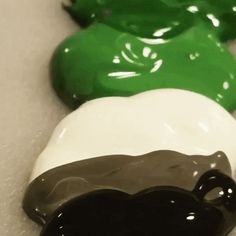 three green and white candy candies sitting next to each other on top of a counter