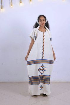 ● Beautifully and carefully made. ● 51 Inchs Long. ● 28 Inches Width. ● very Beautiful and comfortable. ● 100% Made from Cotton. ● It Comes with the Scarf/Headband (Netela) and rope belt (Mekenet) as Shown on the picture. ● Hand Wash Festive White Dress With Weaving Work, White Dresses With Woven Motifs For Festivals, Traditional Long Handloom Dress, White Dresses With Weaving Work For Traditional Ceremonies, Traditional Off White Dress With Pallu, Bohemian Handloom Dresses For Traditional Ceremonies, White Folk Dress With Weaving Work, Bohemian Habesha Kemis For Eid, Bohemian Habesha Kemis For Wedding Festivals