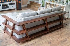 a living room filled with furniture and lots of wooden flooring on top of a hard wood floor