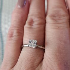 a woman's hand with a diamond ring on it