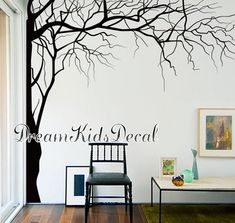 there is a tree with no leaves on it and the words dear kids decal above it