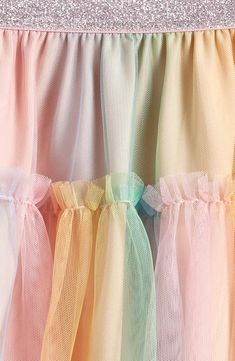 Get your kiddo ready to twist and twirl in this rainbow-tulle skirt topped with a metallic elastic waist for a hint of sparkle. Elastic waist Lined 100% polyester Machine wash, tumble dry Imported Multicolor Playful Tulle Tutu Dress, Whimsical Rainbow Tulle Tutu Dress, Kids Rainbow Skirt, Playful Rainbow Tutu Dress For Dress-up, Pink Playful Unicorn Print Tutu Dress, Tulle Tutu Skirt, Rainbow Kids, Tutu Skirt, Skirt Top