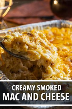 a spoon full of macaroni and cheese with the words creamy smoked mac and cheese