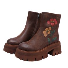 a pair of brown boots with flowers painted on the side and zippers at the bottom