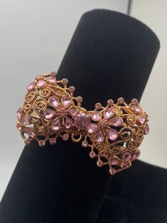 A beautiful Betsy Johnson cuff bracelet, rose gold tone, giant bow with plenty of clear and pink stones! NOTE:  larger pink tear drop stone has come loose, but is included. Rose Gold Bracelet Jewelry For Evening, Rose Gold Bracelet For Evening Wear, Rose Gold Bangle Bracelet For Evening, Evening Jewelry In Rose Gold With Rhinestones, Elegant Pink Metal Crystal Bracelet, Rose Gold Bangle For Evening, Evening Rose Gold Jewelry With Rhinestones, Pink Crystal Bracelet For Formal Occasions, Pink Crystal Bracelets For Formal Occasions