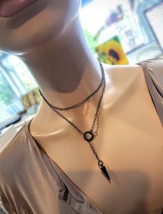 This is a dainty minimalist blackened steel Lariat Necklace Set wrap choker with Spike pendant.  The minimalist design gives it a trendy and stylish feel, while the black steel gives it a touch of gothic Punk edge. This necklace is versatile and can be worn long or doubled up for a layered look. This is a dainty chain, but is strong steel. is you are looking for someone more suitable to "fun and games" please take a look in my shop for more sturdy versions 😉 Approximately 35" or 39" measured en Edgy Adjustable Clavicle Chain Necklace, Punk Style Jewelry With Adjustable Chain For Gifts, Punk Style Necklace With Adjustable Chain For Gift, Edgy Clavicle Chain Jewelry For Gift, Edgy Clavicle Chain Necklace For Gifts, Edgy Gunmetal Jewelry With Adjustable Fit, Adjustable Gunmetal Edgy Jewelry, Edgy Clavicle Chain Jewelry Gift, Adjustable Punk Style Necklace For Gift